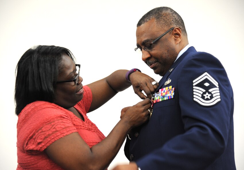 U.S. Air Force Senior Master Sgt. Edward B. Viverette, 927th Mission Support Group and Force Support Squadron first sergeant, gets pinned on by his wife Regina during Viverette’s retirement ceremony on Feb. 6, 2016 at MacDill Air Force Base, Florida. Viverette served faithfully for 33 years in a multitude of roles. (U.S. Air Force photo by Senior Airman Xavier Lockley)