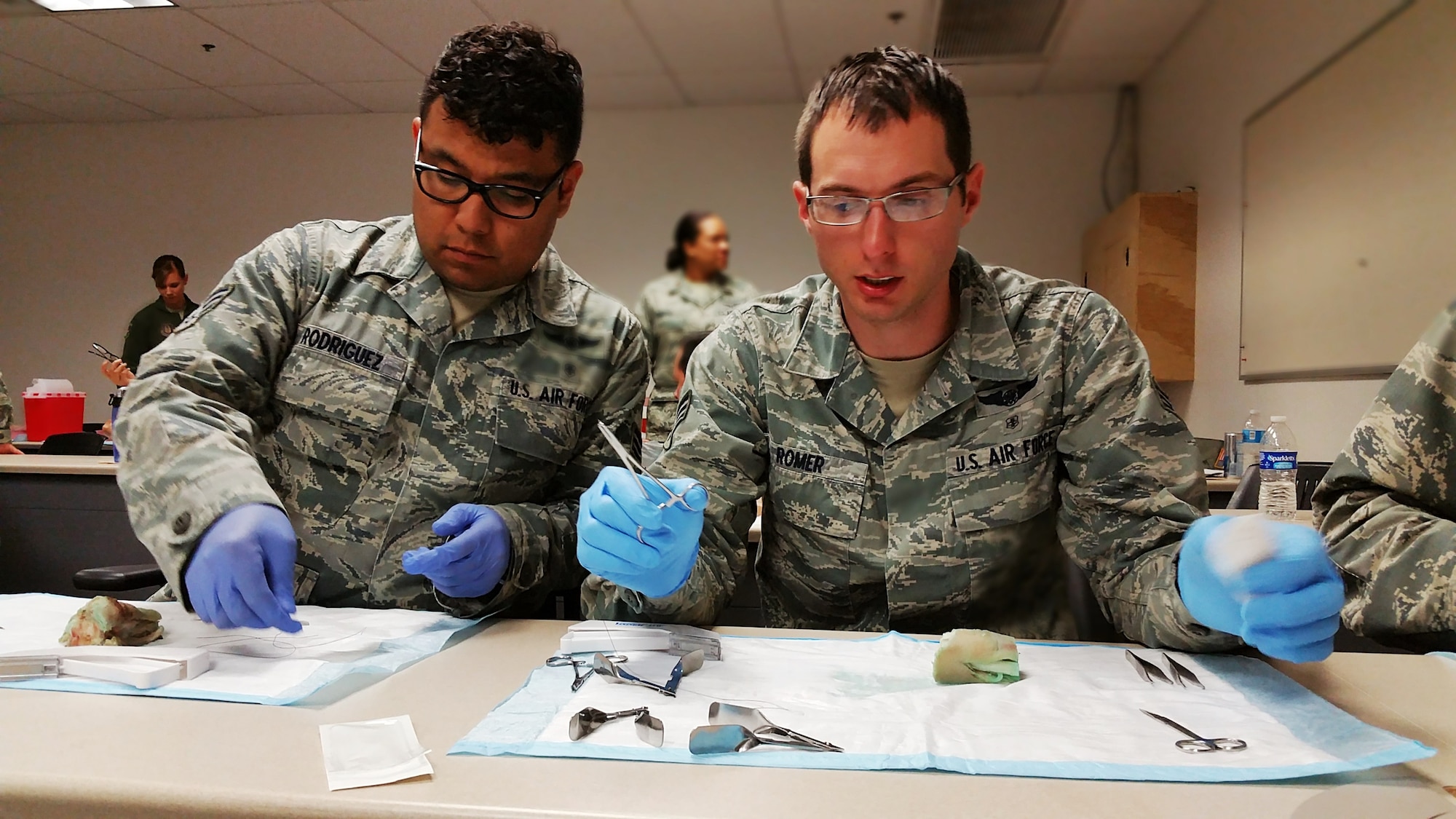 Senior Airmen James Rodriguez and Michael Romer  medical technicians from the 433rd Aeromedical Evacuation Squadron, prepare to practice suturing techniques on pigs feet during the super UTA weekend on March 4, 2016 at Joint Base San Antonio-Lackland, Texas.  Pigs feet are used because they are similar in texture to human skin. (U.S. Air Force photo by Tech. Sgt. Carlos J. Trevino)