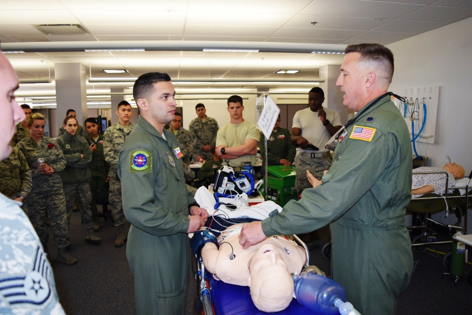 Tech. Sgt. Jay Mejia(left), 433rd Aeromedical Evacuation Squadron medical technician,  listens as Lt. Col. Alex Schwan(right), aeromedical evacuation officer with the 433rd AES, teaches him and other AES Airmen how to drain a chest wound March 4, 2016 at Joint Base San Antonio-Lackland, Texas.  Personnel with the 433rd AES and the 433rd Aeromedical Staging Squadron attended various classes to learn and practice their skills and test their abilities. (U.S. Air Force photo by Tech. Sgt. Carlos J. Trevino)