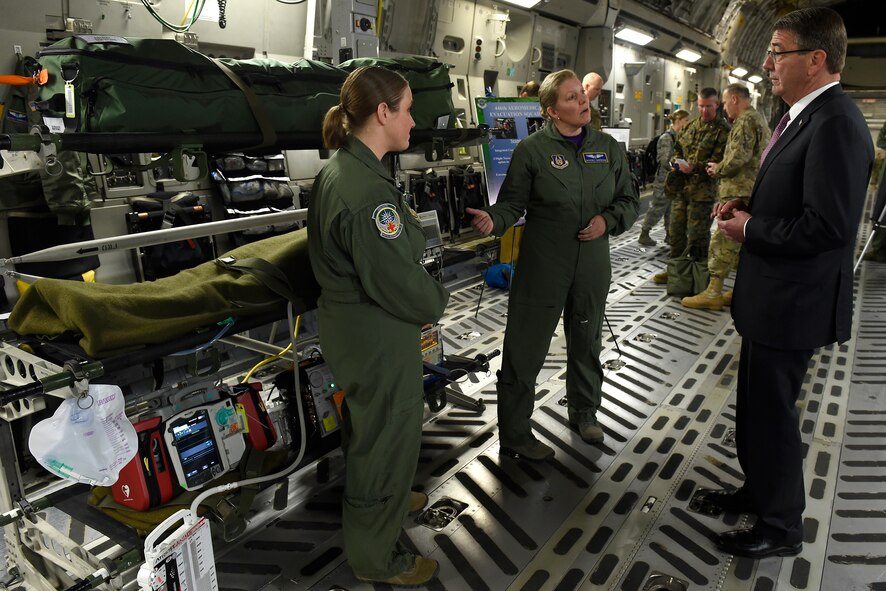 Maj. Beverly Davidson (center), 446th Aeromedical Evacuation Squadron flight nurse, and Tech. Sgt. Kassy Kvam (left), 446th AES technician, brief Defense Secretary Ash Carter about aeromedical evacuation procedures March 4, 2016 at Joint Base Lewis-McChord, Wash. Carter spoke of the total force concept here at JBLM and this was just one demonstration that highlighted that.  (U.S. Air Force photo/Tech. Sgt. Tim Chacon) 