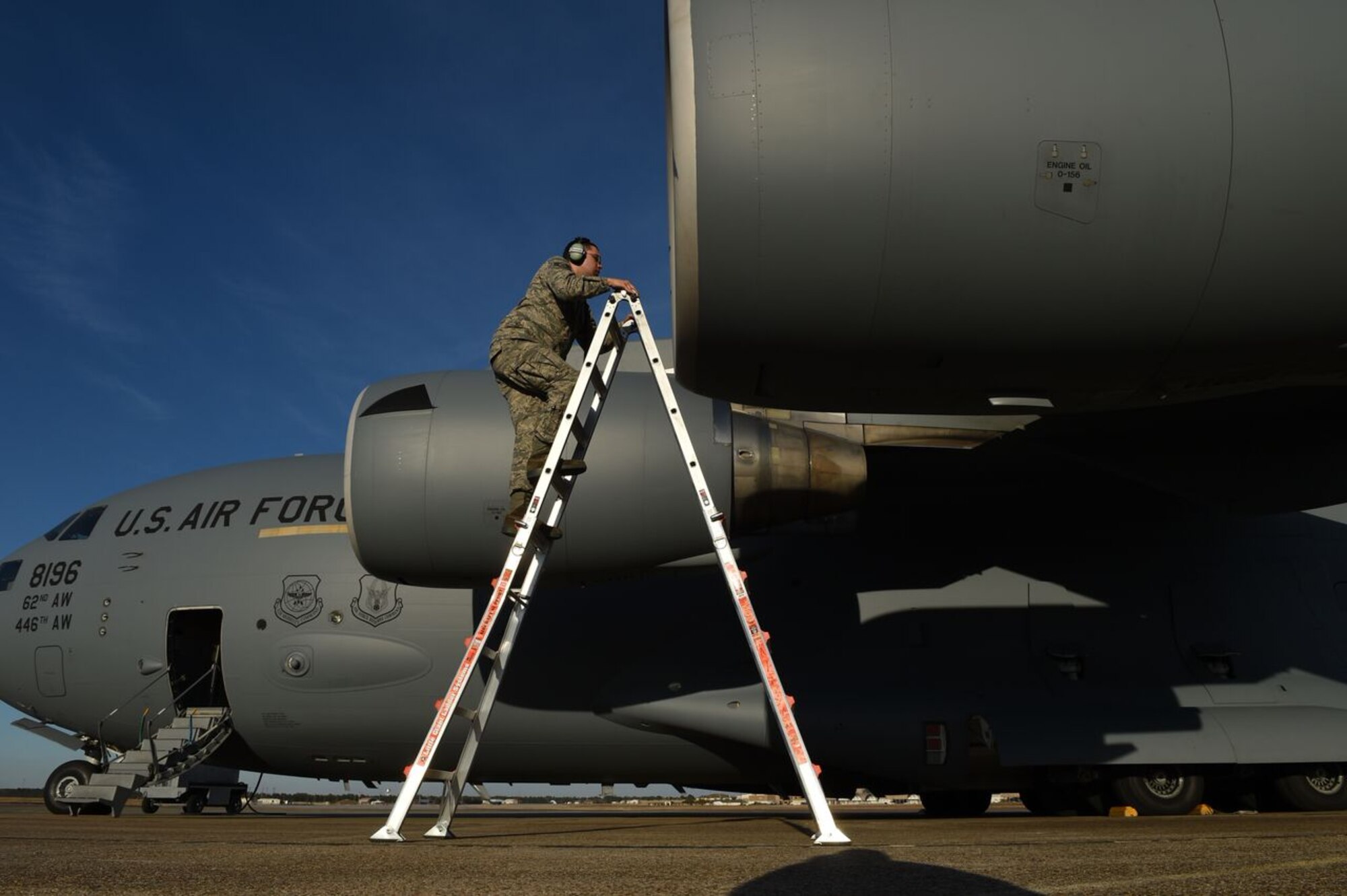 Staff Sgt. Arthur Mendoza, 62nd Aircraft Maintenance Squadron crew chief, climbs a ladder to inspect an engine during a pre-flight check on a McChord Field C-17 Globemaster III on the flight line at Eglin Air Force Base, Fla., March 2, 2016. Mendoza traveled with the C-17 aircrew from Joint Base Lewis-McChord, Wash., to participate in a flare effectiveness test. Mendoza’s job is to ensure the aircraft is operating the way it should be to ensure safety for the aircraft and crew. (U.S. Air Force photo/Staff Sgt. Naomi Shipley)