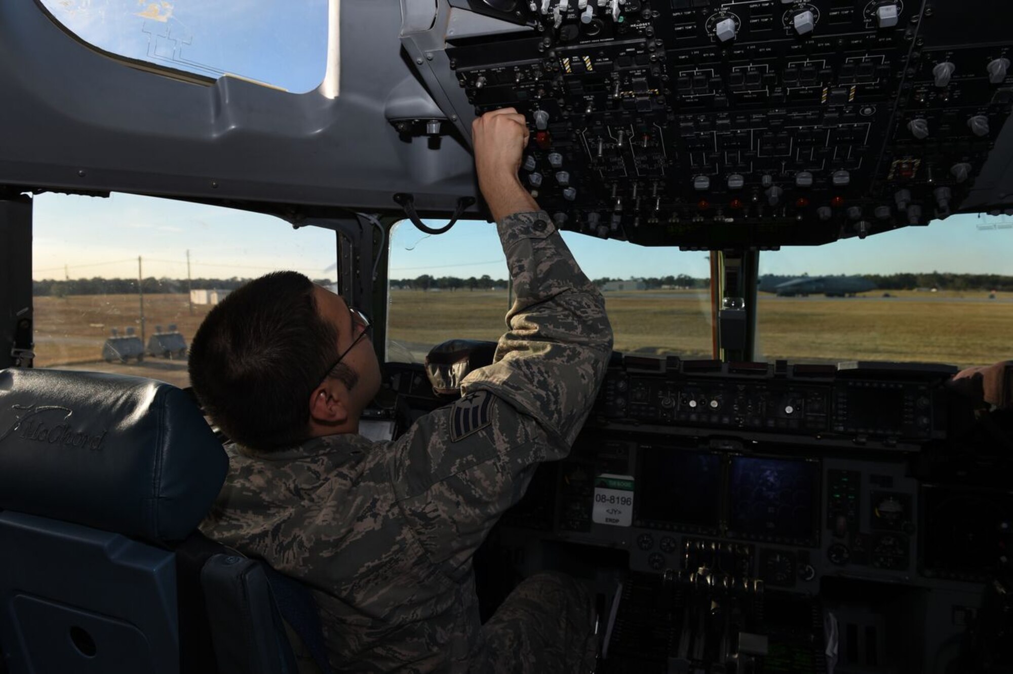 Staff Sgt. Arthur Mendoza, 62nd Aircraft Maintenance Squadron crew chief, performs pre-flight checks on a McChord Field C-17 Globemaster III on the flight line at Eglin Air Force Base, Fla., March 2, 2016. Mendoza and an air crew from Joint Base Lewis-McChord, Wash., participated in Air Mobility Command aircraft flare effectiveness testing. (U.S. Air Force photo/Staff Sgt. Naomi Shipley)
