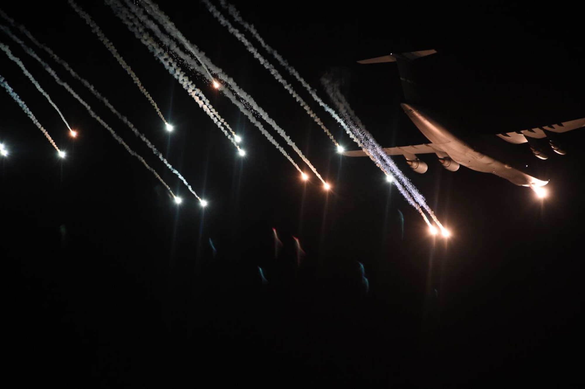 A C-5 from Travis Air Force Base, Calif., ejects flares over the Eglin Range March 2, 2016, at Eglin AFB, Fla. The C-5 aircraft was participating in Air Mobility Command flare effectiveness testing at Eglin AFB  to ensure the infrared countermeasures are working as intended. The C-5 and C-17 ejected several flare patterns over a week long testing period. (U.S. Air Force photo/Staff Sgt. Naomi Shipley)