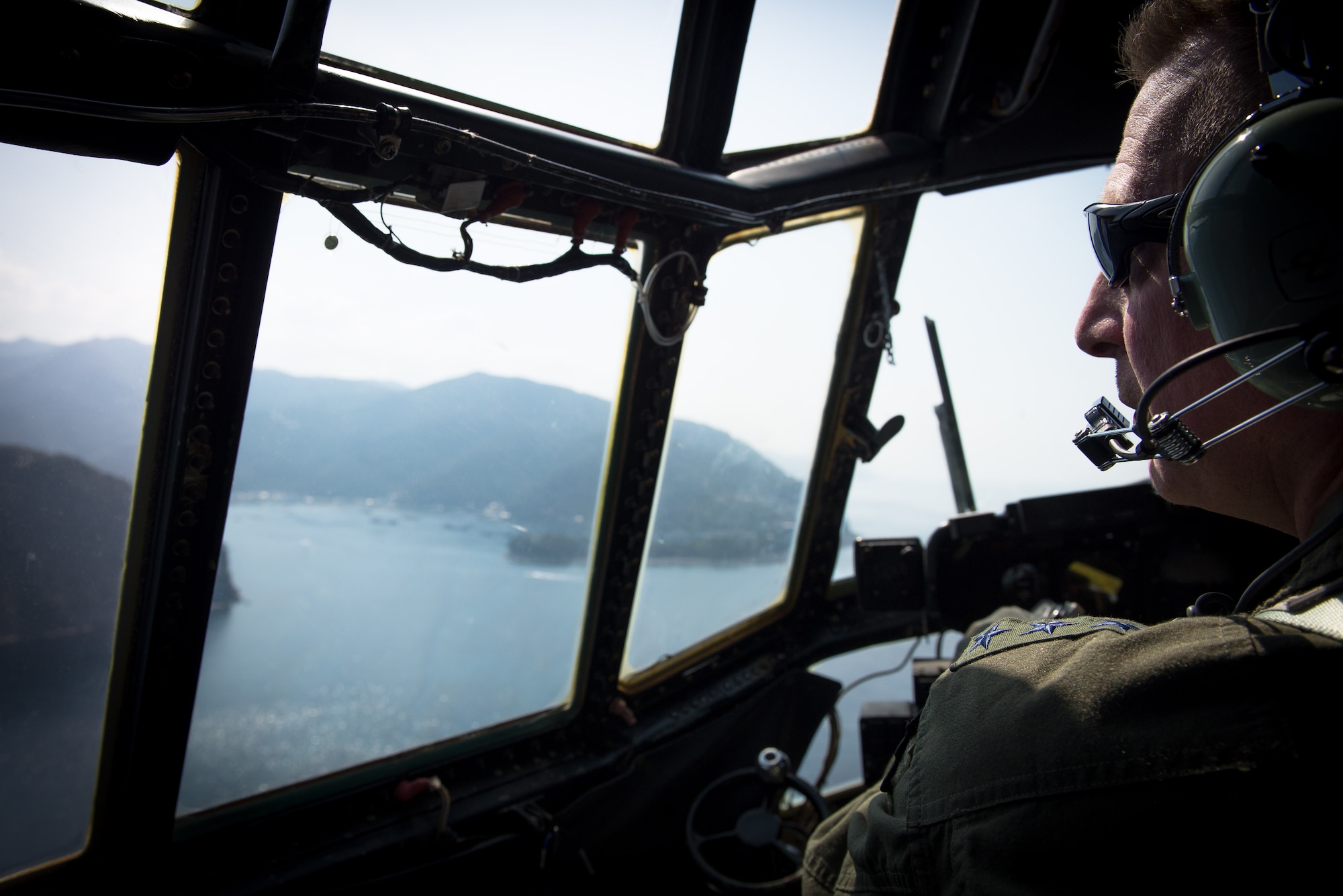 Lt. Gen. John Dolan, U.S. Forces, Japan and 5th Air Force commander, pilots a C-130 Hercules off the coast of Izu Peninsula, Japan, March 4, 2016. As a former F-16 Fighting Falcon pilot, this was Dolan’s first time flying a C-130 Hercules.  (U.S. Air Force photo by Staff Sgt. Michael Smith/Released)   