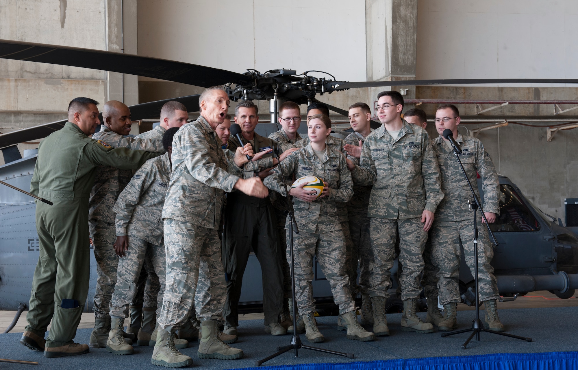 U.S. Air Force Col. Steven McCain, Pacific Air Forces command chaplain, demonstrates wingmanship with audience members at an annual National Prayer Luncheon, March 2, 2016, at Kadena Air Base, Japan. McCain used the game of rugby as a metaphor to show that people are never alone.  (U.S. Air Force photo by Airman 1st Class Lynette M. Rolen)