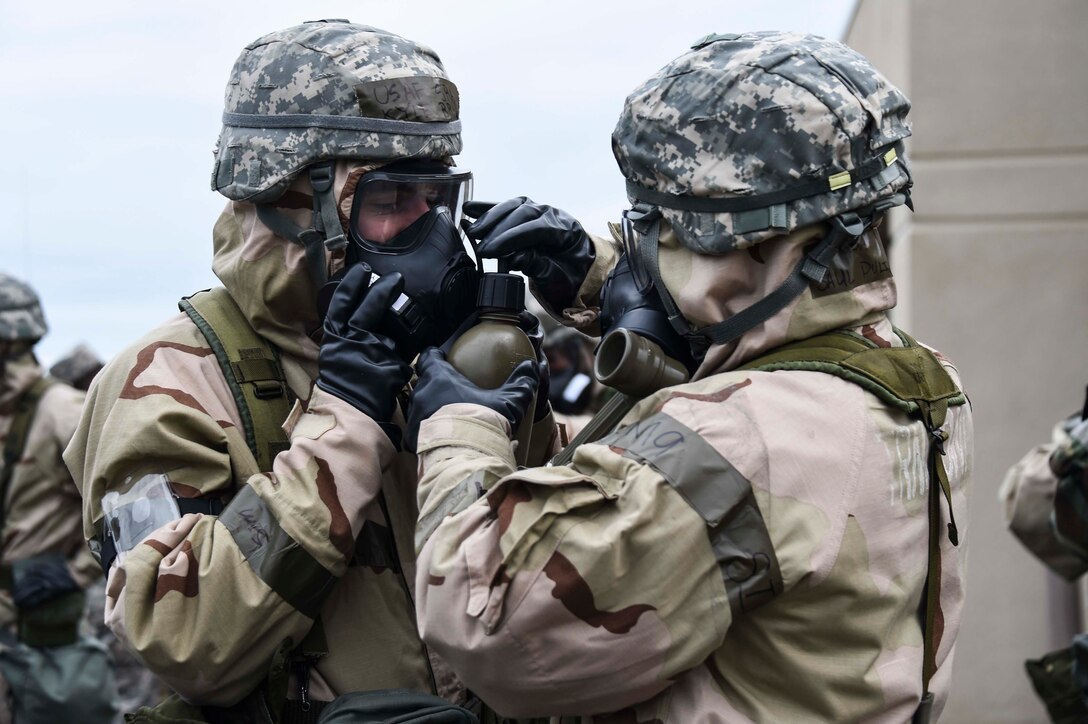 Airmen assigned to the 144th Fighter Wing help each other drink water using a canteen and gas mask ear as part of the chemical, biological, radiological, and nuclear training portion of the expeditionary skills course held at the Fresno Air National Guard Base March 5, 2016.  The ESC included training in both CBRN and self-aid and buddy care. (U.S. Air National Guard photo by Senior Airman Klynne Pearl Serrano)