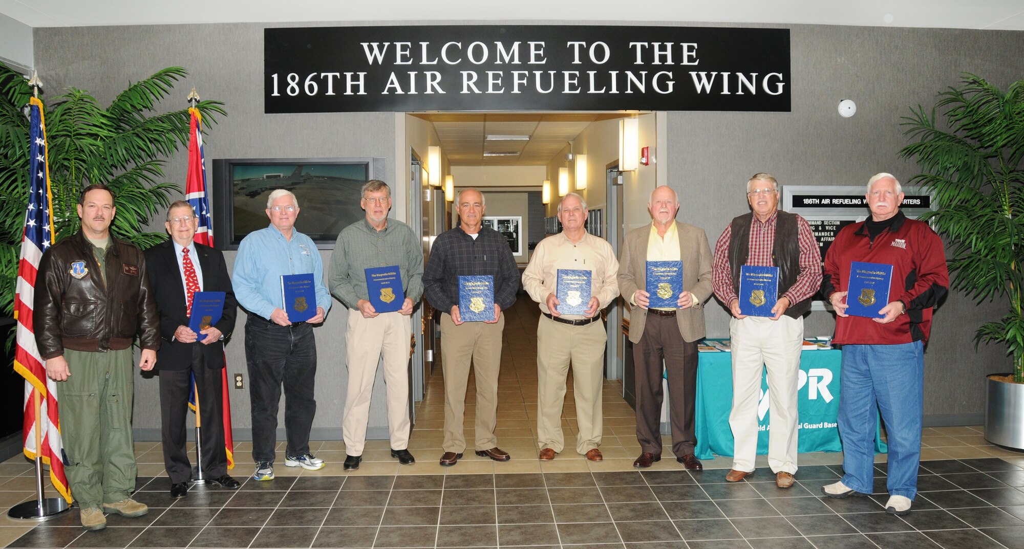 Col. Mike Nabors, 186th Air Refueling Wing commander, presents retired wing commanders and command chiefs with The Magnolia Militia history book on Key Field Air National Guard Base, January 29, 2016. Retired Gens. Sam Forbert Jr., Erik Hearon, Jim White, and Franklin Chalk along with retired Command Chief Master Sgts. Billy Allen, Ron Holloway, Gerald Goodin, and Lindsey Keene were briefed by Nabors on the past of Key Field and informed of present and future conditions of the base.  (U. S. Air National Guard photo by Senior Master Sgt. Richard Davis/Released)