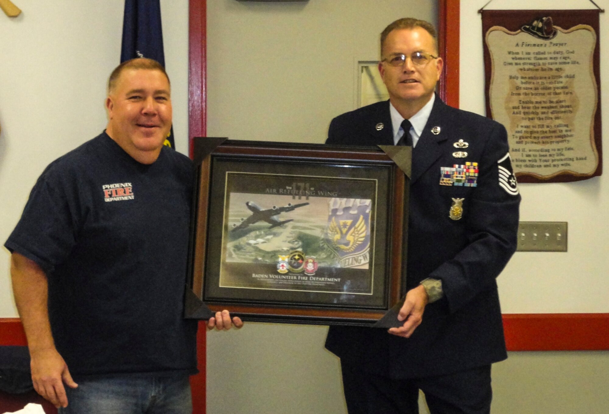 Master Sgt. Gary L. Shannon, 171st Installation Fire Chief, presents an appreciation award to Dave Trzciankia , Fire Chief of the Baden Volunteer Fire Department, Dec. 3, 2015. (U.S. Air National Guard Photo)