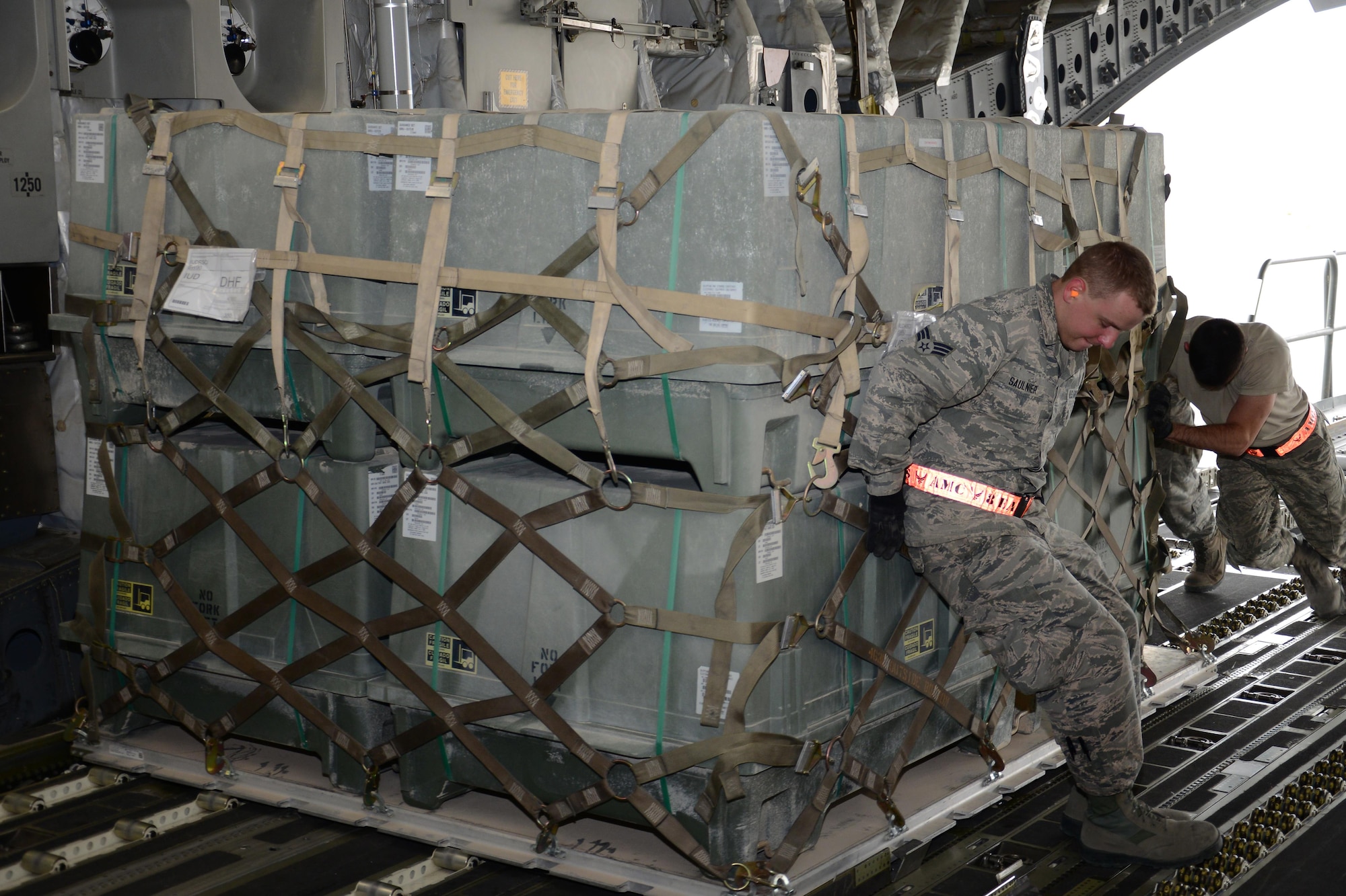 Airmen from the 8th Expeditionary Air Mobility Squadron Ramp Services team load munitions onto a C-17 Globemaster III from Travis Air Force Base, Calif., at Al Udeid Air Base, Qatar Feb. 26 in support of Operation Inherent Resolve. In February the team loaded more than 3,500 tons of cargo onto U.S. aircraft. (U.S. Air Force photo by Tech. Sgt. James Hodgman/Released) 