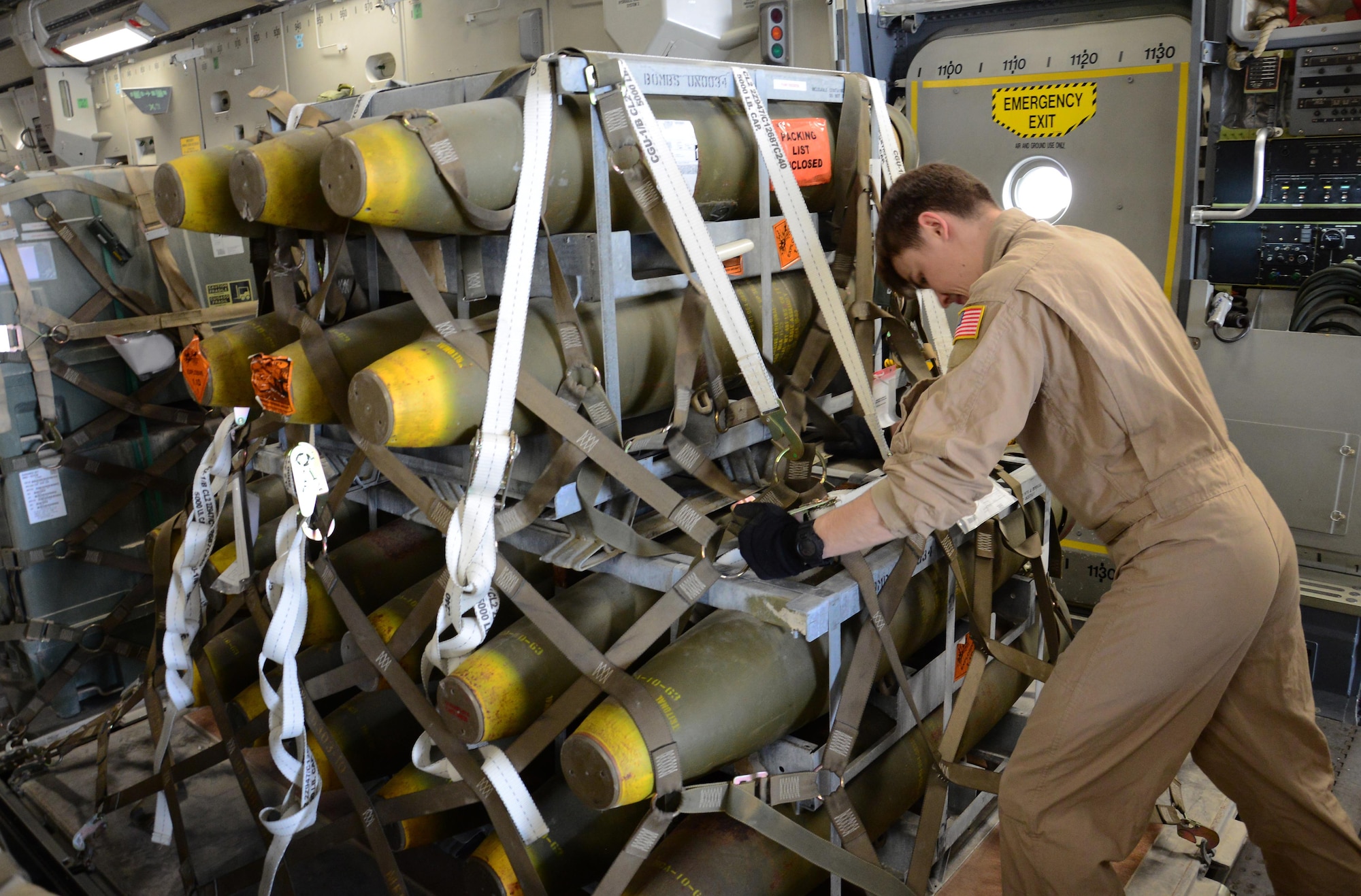 A deployed aircrew member pushes a pallet of munitions onto a C-17 Globemaster III from Travis Air Force Base, Calif., at Al Udeid Air Base, Qatar Feb. 26 in support of Operation Inherent Resolve. In February, the 8th Expeditionary Air Mobility Squadron loaded more than 3,500 tons of cargo onto U.S. aircraft. (U.S. Air Force photo by Tech. Sgt. James Hodgman/Released) 