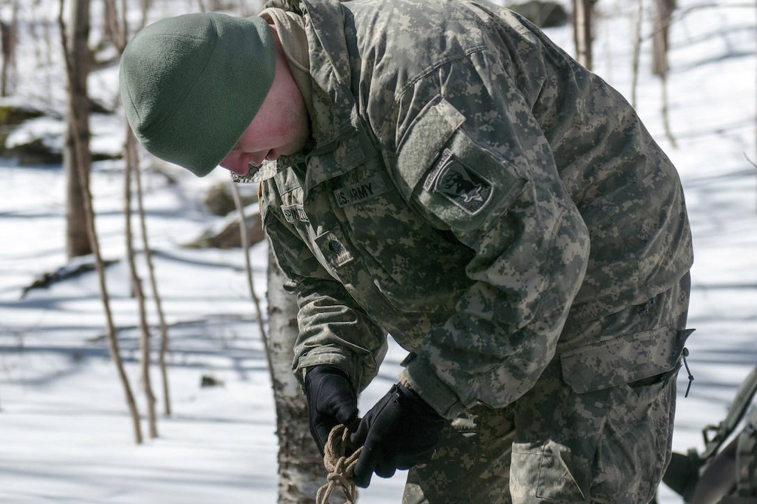 A soldier unties a knot while setting up tents at Smuggler's Notch in Jeffersonville, Vt., March 5, 2016. Vermont Army National Guard photo by Spc. Avery Cunningham