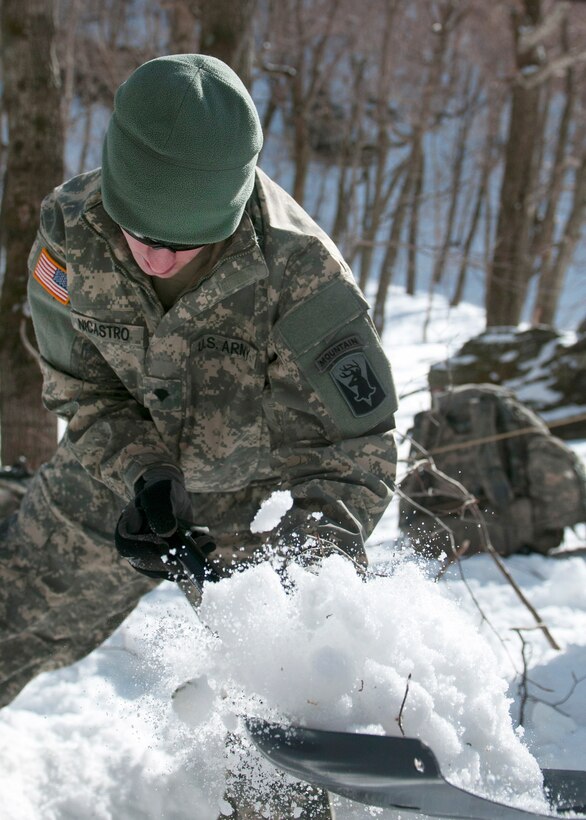 Army Spc. Nicastro shovels snow to secure a tent at Smuggler's Notch in Jeffersonville, Vt., March 5, 2016. Nicastro is assigned to the Vermont National Guard’s Company A, 3rd Battalion, 172nd Infantry Regiment, 86th Infantry Brigade Combat Team, Mountain. Vermont Army National Guard photo by Spc. Avery Cunningham
