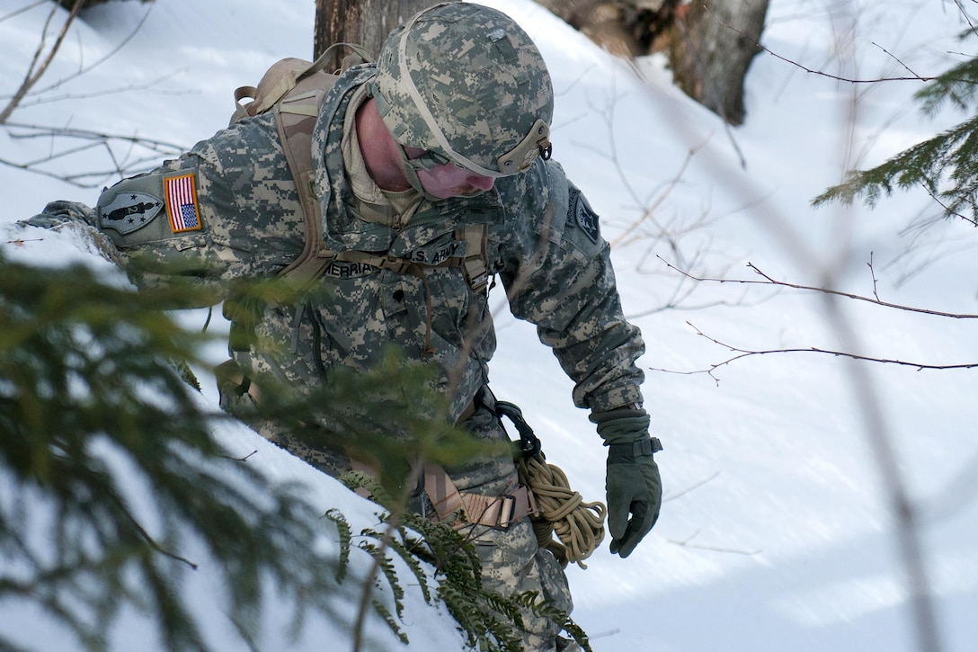 Army Spc. Isaac Merriam traverses a mountain at Smuggler's Notch in Jeffersonville, Vt., March 5, 2016. Merriam is an infantry team leader assigned to the Vermont National Guard’s Company A, 3rd Battalion, 172nd Infantry Regiment, 86th Infantry Brigade Combat Team, Mountain. Vermont Army National Guard photo by Spc. Avery Cunningham
