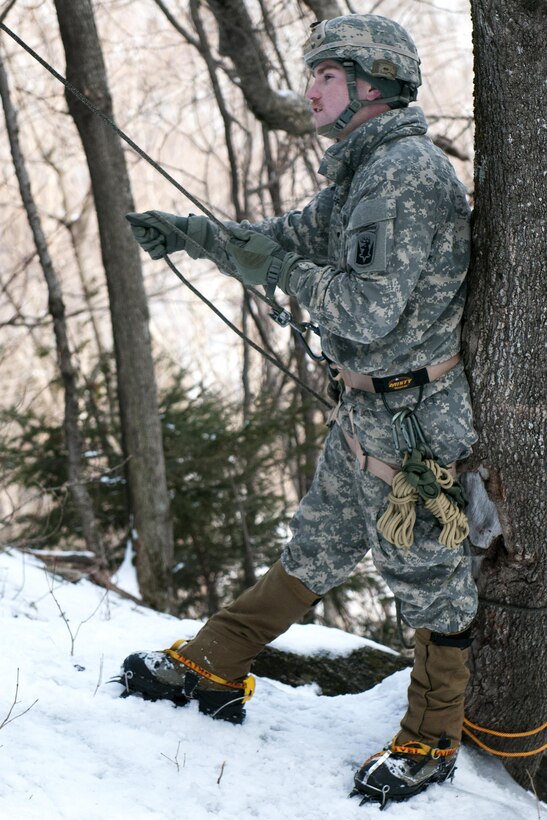 Army Spc. Isaac Merriam belays another soldier at Smuggler's Notch in Jeffersonville, Vt., March 5, 2016. Merriam is an infantry team leader assigned to the Vermont National Guard’s Company A, 3rd Battalion, 172nd Infantry Regiment, 86th Infantry Brigade Combat Team, Mountain. Vermont Army National Guard photo by Spc. Avery Cunningham