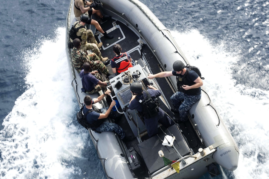 Cameroon navy sailors, U.S. Coast Guard Law Enforcement Detachment, and U.S. sailors participate in small boat operations aboard a rigid hull inflatable boat assigned to the USNS Spearhead in the Atlantic Ocean, March 3, 2016. Navy photo by Petty Officer 3rd Class Amy M. Ressler