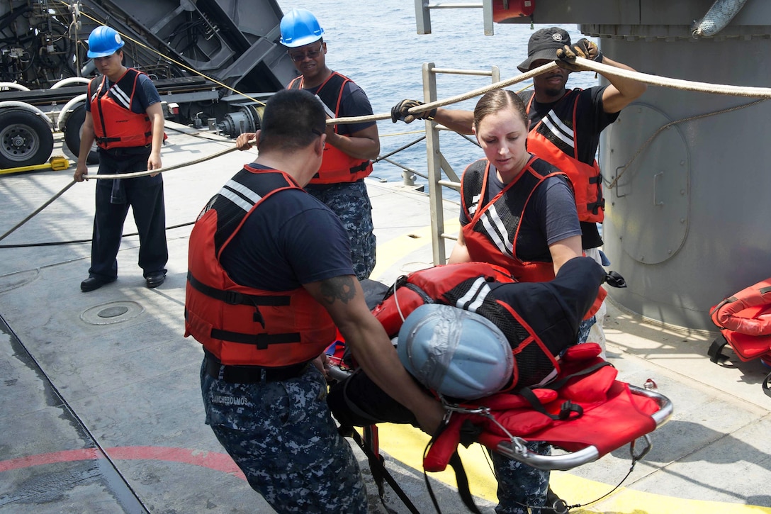 Navy Petty Officer 1st Class Vanessa Poland, right, and Navy Petty Officer 1st Class Hugo Sanchezolmos participate in a man overboard drill aboard USNS Spearhead in the Atlantic Ocean, March 3, 2016. Poland and Sanchezolmos are hospital corpsmen. Navy photo by Petty Officer 3rd Class Amy M. Ressler