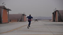 Staff Sgt. Nathan Lewis, 36th Aircraft Maintenance Unit dedicated crew chief, runs toward an F-16 Fighting Falcon before bringing it to a stop for post-flight checks March 7, 2016, at Osan Air Base, Republic of Korea. Members of the 36th Aircraft Maintenance Unit generated multiple aircraft throughout the day in preparation for combat readiness exercise Beverly Midnight 16-01. (U.S. Air Force photo Staff Sgt. Benjamin Sutton/Released)