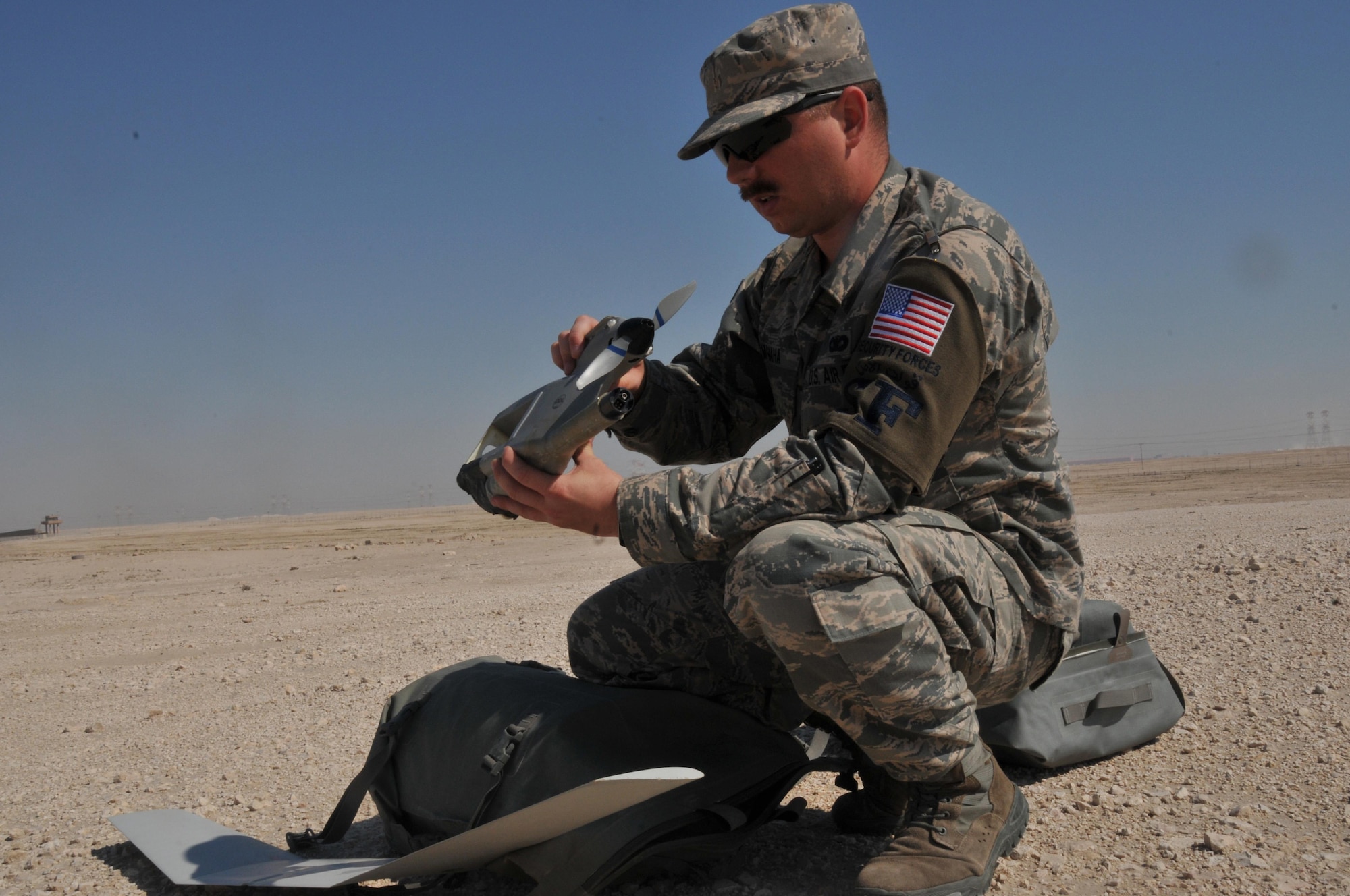 Senior Airman James McGaha, 379th Expeditionary Security Force Squadron patrolman, puts together a Raven B Digital Data Link drone, a small unmanned aircraft or drone, Feb. 19 at Al Udeid Air Base, Qatar. McGaha is a member of a two person team who operate the Raven B drone at AUAB. He is deployed from Yokota Air Base, Japan, and has been a patrolman for three years. (U.S. Air Force photo by Tech. Sgt. Terrica Y. Jones/Released) 