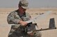 Senior Airman James McGaha, 379th Expeditionary Security Force Squadron patrolman, recovers parts of the Raven B Digital Data Link drone Feb. 19, 2016, at Al Udeid Air Base, Qatar. After completing its flight, the Raven’s wings detached after landing which can occur and is easy to fix. (U.S. Air Force photo/Tech. Sgt. Terrica Y. Jones)