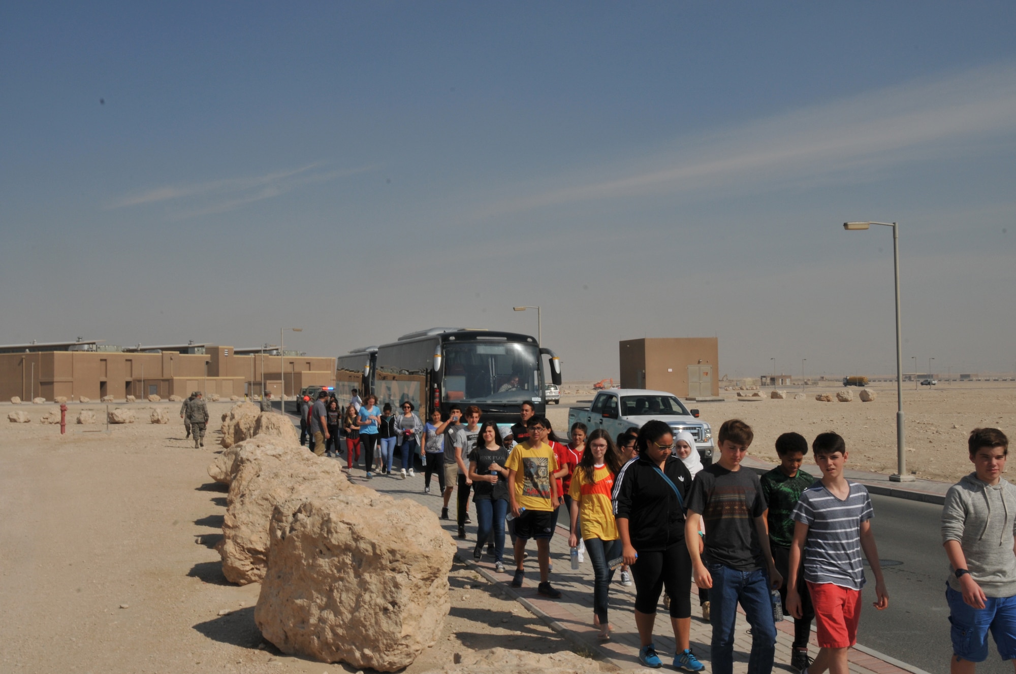 Approximately 200 eighth grade students from the American School of Doha visits Al Udeid Air Base, Qatar, Mar. 3. Students were able to ask questions about different jobs and see static displays of vehicles and aircraft during their visit. (U.S. Air Force photo by Tech. Sgt. Terrica Y. Jones)