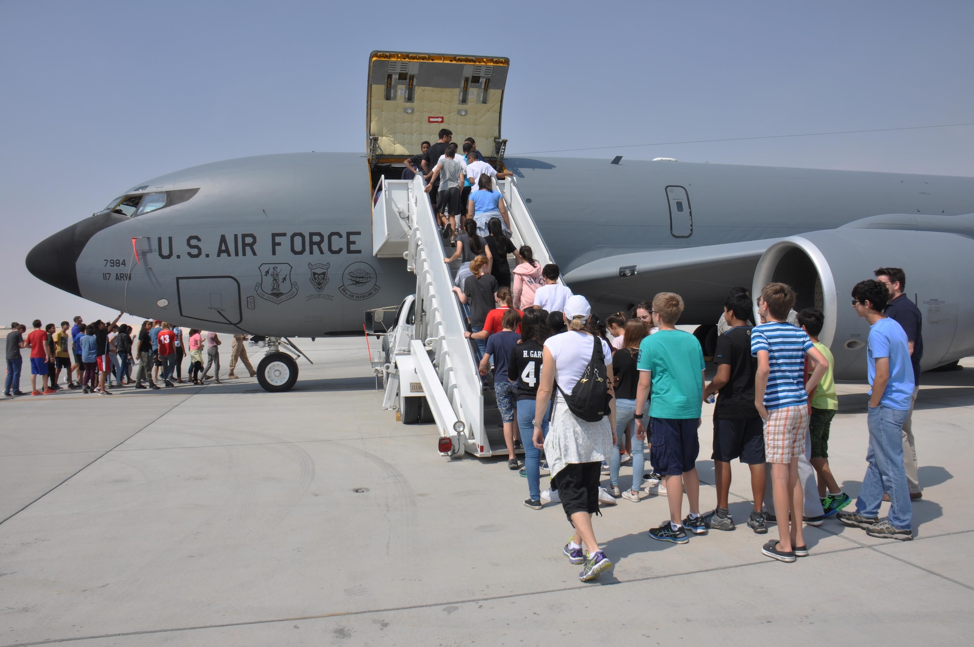 Approximately 200 American School of Doha students tour a KC-135 Stratotanker during a visit to Al Udeid Air Base, Qatar March 3. The students also received briefings on the aircraft’s capabilities. During the visit, students watched a military working dog demonstration and met with U.S. Airmen from a variety of specialties. (U.S. Air Force photo by Tech. Sgt. James Hodgman/Released) 