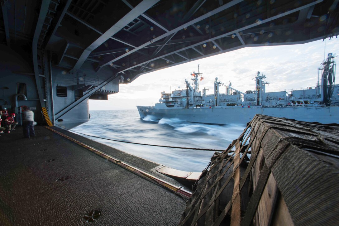 The aircraft carrier USS John C. Stennis pulls alongside the fast combat support ship USNS Rainier during a replenishment in the South China Sea, March 4, 2016. The Stennis is operating as part of the Great Green Fleet on a regularly scheduled 7th Fleet deployment. Navy photo by Petty Officer 3rd Class Kenneth Rodriguez Santiago