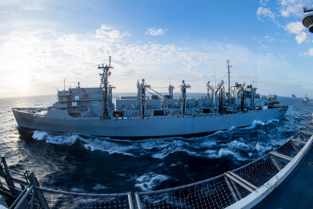 The aircraft carrier USS John C. Stennis participates in a replenishment at sea with the fast combat support ship USNS Rainier while the guided-missile cruiser USS Mobile Bay approaches to receive an advanced biofuel mixture in the South China Sea, March 4, 2016. Navy photo by Petty Officer 3rd Class Andre T. Richard