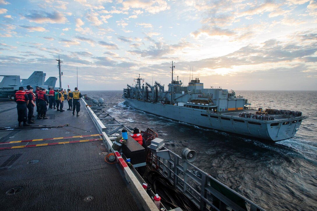 The aircraft carrier USS John C. Stennis approaches the fast combat support ship USNS Rainier during a replenishment at sea in the South China Sea, March 4, 2016. Navy photo by Petty Officer 3rd Class Andre T. Richard