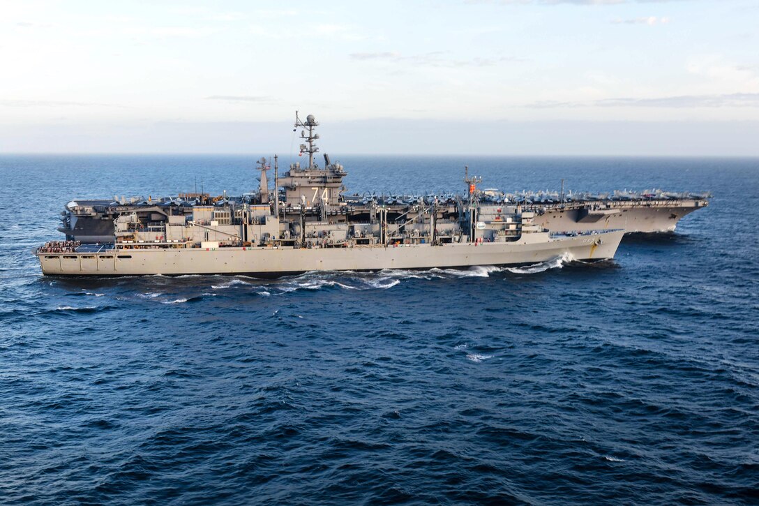 The aircraft carrier USS John C. Stennis pulls alongside the fast combat support ship USNS Rainier during a replenishment at sea in the South China Sea, March 4, 2016. Navy photo by Petty Officer 2nd Class Andrew P. Holmes