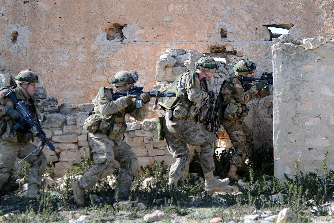 Paratroopers move along a wall in a stack formation before preparing to clear a building during Exercise Sky Soldier 16 at Chinchilla training area in Albacete, Spain, Feb. 29, 2016. Army photo by Staff Sgt. Opal Vaughn