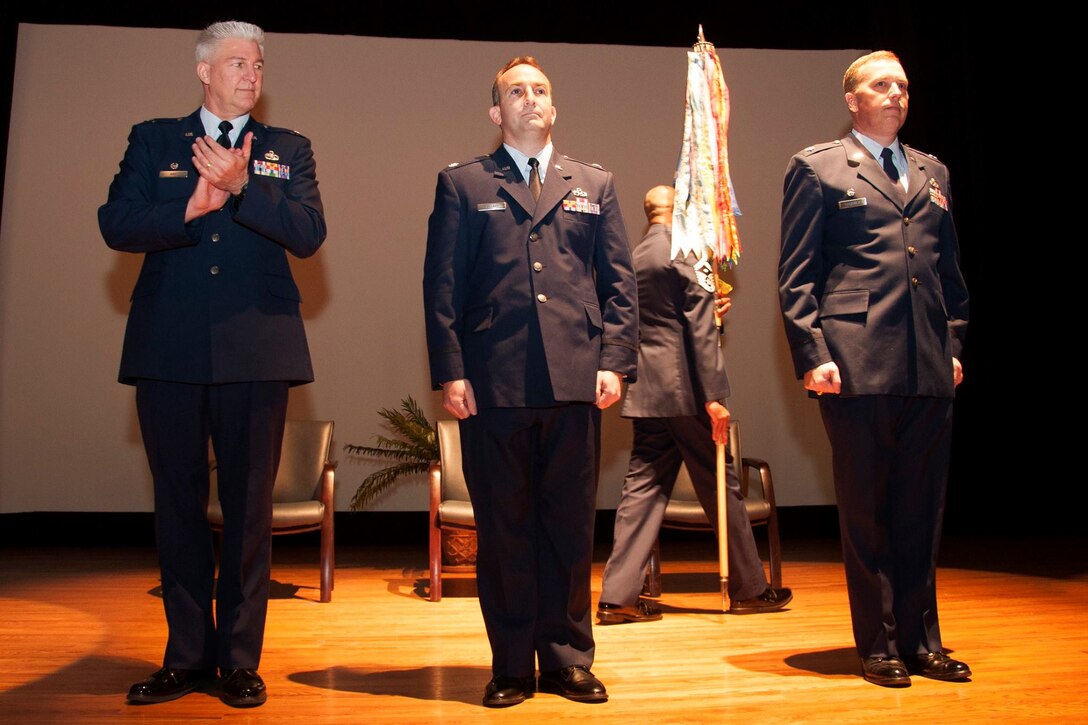 Lt. Col. Keith Eubanks (center) assumed command of the 315th Maintenance Squadron. March 6, , and Lt. Col. Walter R. Fletcher (right), the former commander is the new 315th Maintenance Group deputy commander. Col. Richard Gay, 315th MXG commander (left) congratulates them. Friends, family, and leadership celebrated the change of command ceremony at the base theater at JB Charleston, S.C.  (U.S. Air Force photo by Staff Sgt. Bobby Pilch)