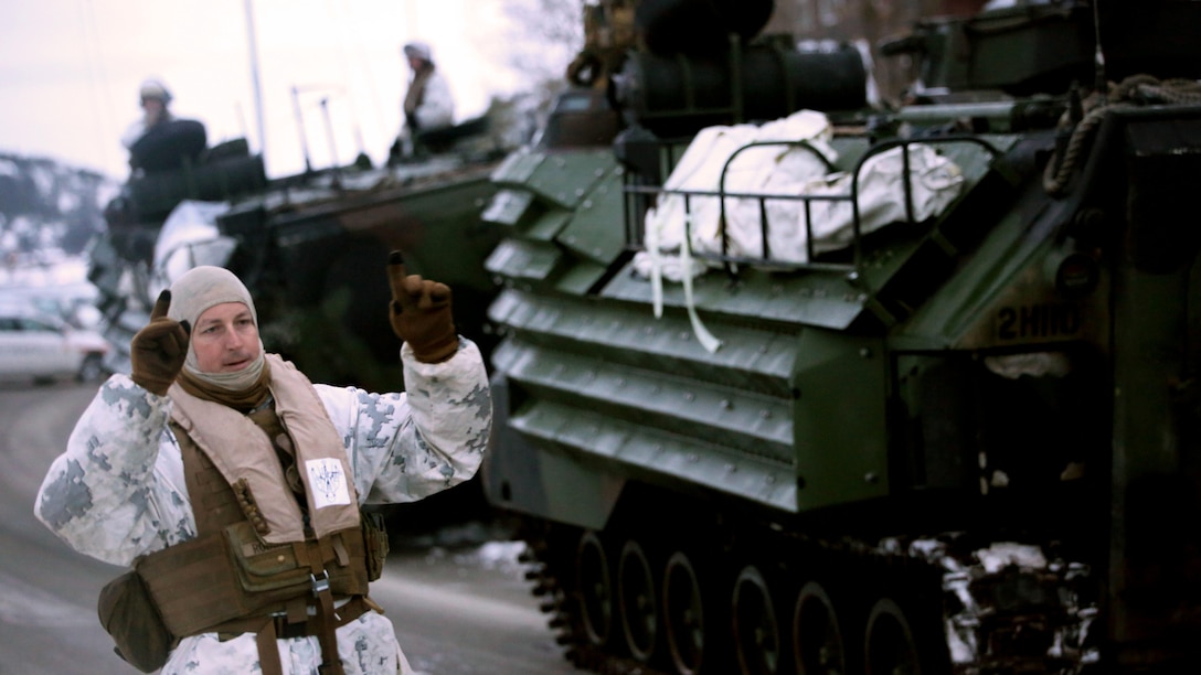 A Marine with 2nd Assault Amphibian Battalion directs a vehicle in Namsos, Norway, March 3, 2016, during Exercise Cold Response 16. The landing reinforced the unit’s capabilities of operating in winter terrain and cold-weather environments. During Cold Response, 13 NATO allies and partner nations and about 15,000 troops enhance their skill sets and strengthen their bonds.