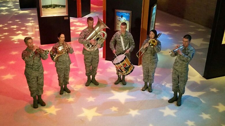 Wright Brass, part of the U.S. Air Force Band of Flight, performs the Air Force Song at the National Museum of the U.S. Air Force. This photo was taken during production of a video commemorating the 25th anniversary of Operation Desert Storm. (U.S. Air Force photo)