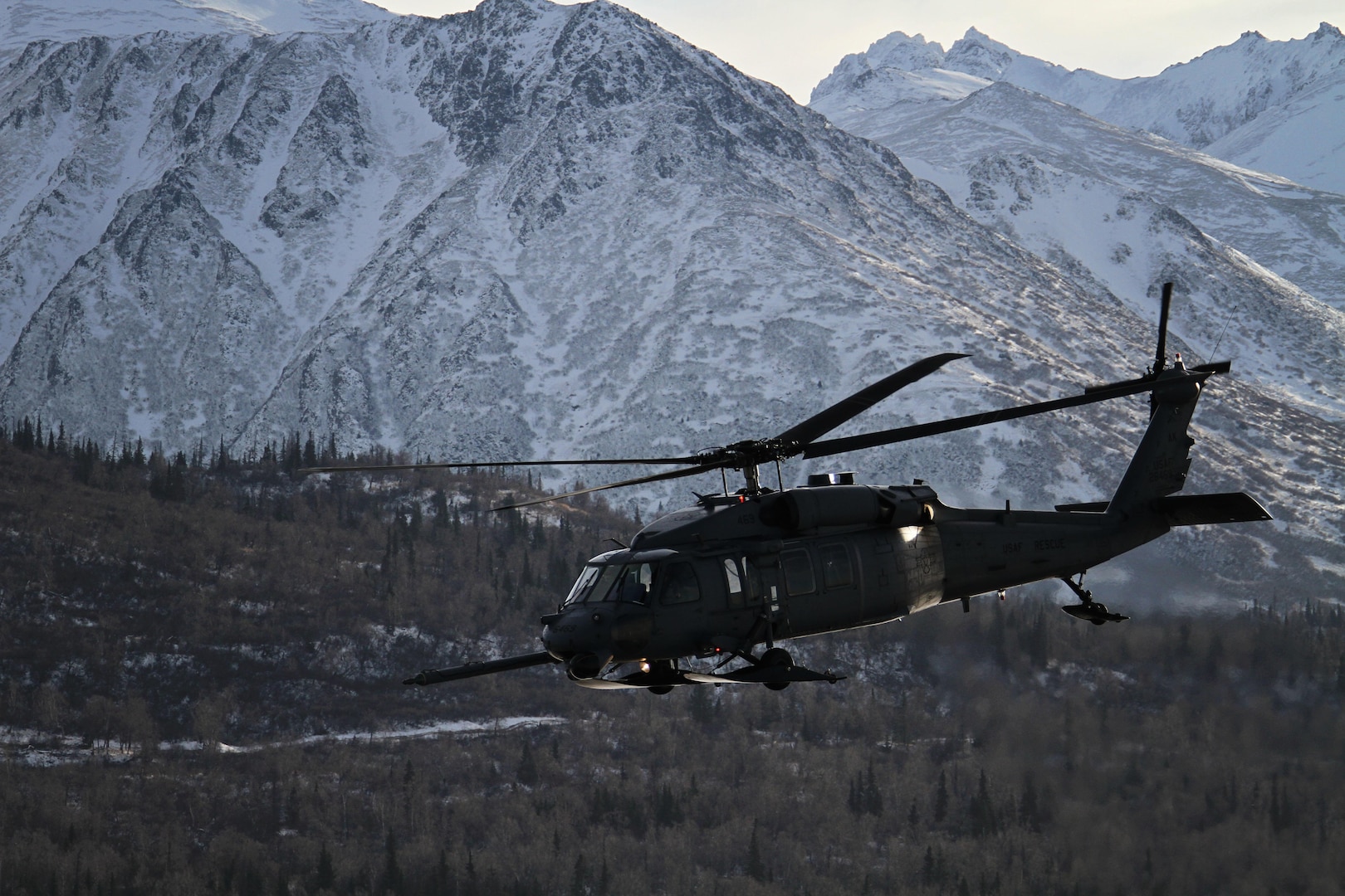 An Alaska Air National Guard HH-60 Pave Hawk, from the 210th Rescue Squadron, is on a training flight near Joint Base Elmendorf-Richardson in February 2013. Rescuers used a similar aircraft to save an injurned snowmobniler on March 5, 2016.