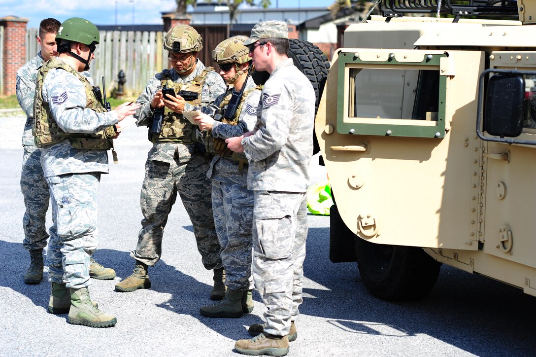 Airmen from the 315th Civil Engineering Flight conduct an exercise at their training facility at Joint Base Charleston, S.C., March 5, 2016. Members faced a scenario that required the cooperation between their firefighters, emergency management and explosive ordinance device units in order to develop a safe solution, while properly using their safety equipment. (U.S. Air Force photo by Senior Airman Jonathan Lane)