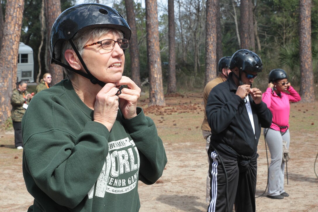 Judy Johnson hooks her helmet on in preparation for scaling down the 50 foot rappel tower March 3, 2016, aboard Marine Corps Recruit Depot Parris Island, S.C. Every recruit going through Marine Corps bootcamp rappels from the tower. As a part of a three-day Educators Workshop, teachers are brought to the island to get a taste of what bootcamp is like.  Johnson is a youth counselor and math teacher at Central Gwinnett High School in Lawrenceville, Ga. (Official Marine Corps photo by Cpl. Diamond N. Peden/Released)