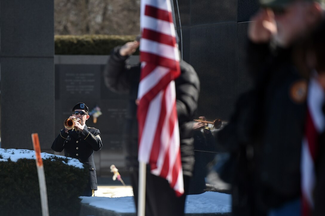 An Army Reserve soldier, assigned to the 85th Army Band, plays taps during the memorial service for Army Spc. Adriana Salem at the Memory Gardens cemetery in Arlington Heights, Ill., March 4, 2016. Sandra Salem, mother of Salem, held the memorial on the 11th anniversary of her daughter’s death. Attendees included Congresswoman Tammy Duckworth, former Illinois Gov. Patrick Quinn, Illinois Patriot Guard, and Army Reserve soldiers from the 85th Support Command and 85th Army Band. Salem, assigned to the 3rd Infantry Division, was killed in Remagen, Iraq, on March 4, 2005.(U.S. Army photo by Mr. Anthony L. Taylor/Released)