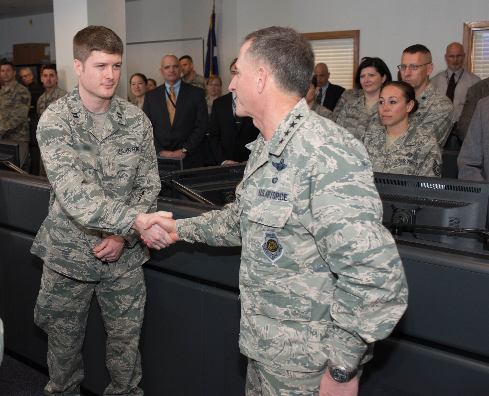 Air Force Vice Chief of Staff Gen. David Goldfein, right, congratulates Capt. Andrew, a flight commander assigned to the 70th Intelligence, Surveillance and Reconnaissance Wing, after presenting him a coin. While deployed, the captain fielded a new quick reaction technology for which he earned the Bronze Star. The Air Force does not fully identify ISR personnel for security reasons.
