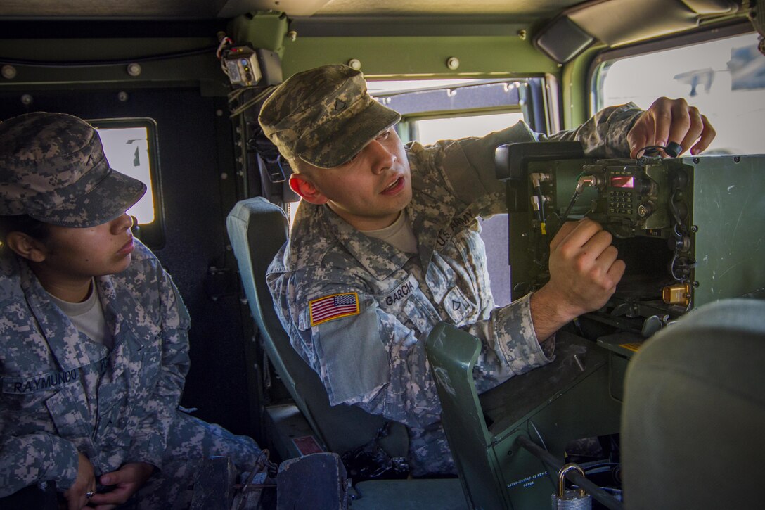 Pfc. Edwin Garcia instructs Soldiers in the 311th Sustainment Command (Expeditionary) on how to set up radio communications and adjust frequencies inside a Humvee during their Battle Assembly March 6, 2016. The 311th ESC is increasing tactical training to prepare Soldiers for their Annual Training in June, 2016, Los Angeles.