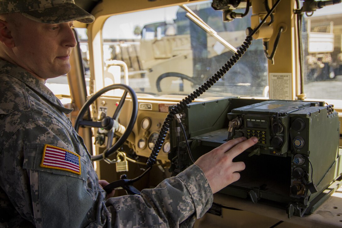 Pfc. Michael Wagner, 311th Sustainment Command (Expeditionary) sets up a radio to test communication between Humvees during their Battle Assembly March 6, 2016. The 311th ESC is increasing tactical training to prepare Soldiers for their Annual Training in June, 2016, Los Angeles.