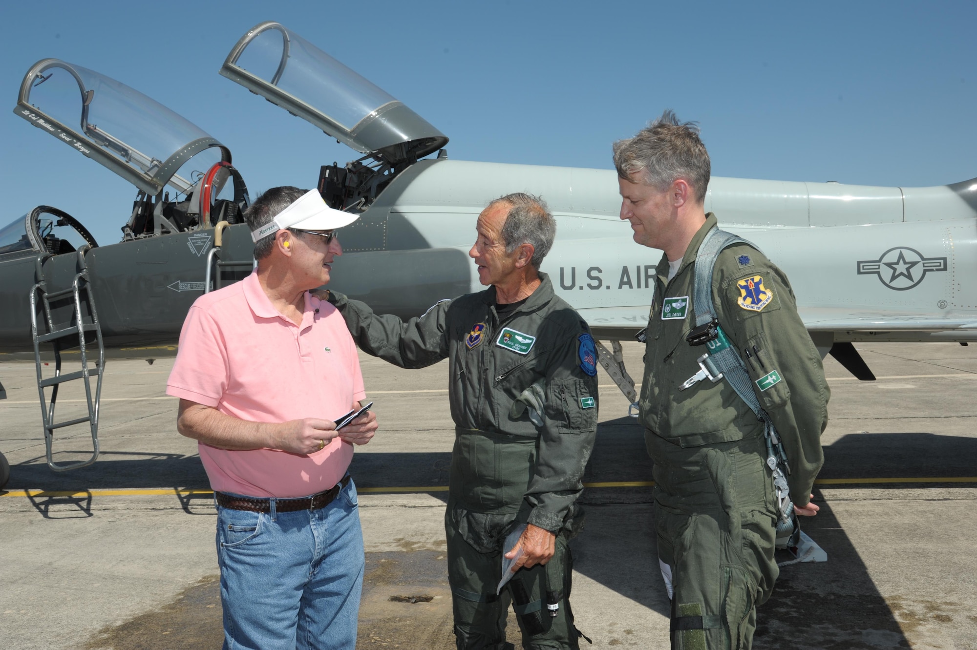 Lt. Col. Joel Deboer (right), 560th Flying Training Squadron commander and Paul Granger (middle), present "Freedom Flight" patches to Thomas Klomann at Joint Base San Antonio-Randolph, Texas, March 3, 2016. Granger and Klomann were shot down in the same B-52 Stratofortress while on a combat mission near Hanoi in North Vietnam on December 20, 1972, in support of Operation Linebacker II.