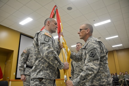 U.S. Army Reserve Command Sgt. Maj. Michael Boyd (right), senior enlisted adviser, 411th Engineer Brigade, passes the brigade colors to Col. Ralph Henning, outgoing commander, 411th Engineer Brigade, during the change of command ceremony March 5 in New Windsor, N.Y. (U.S. Army photo by Nathan Fanton)