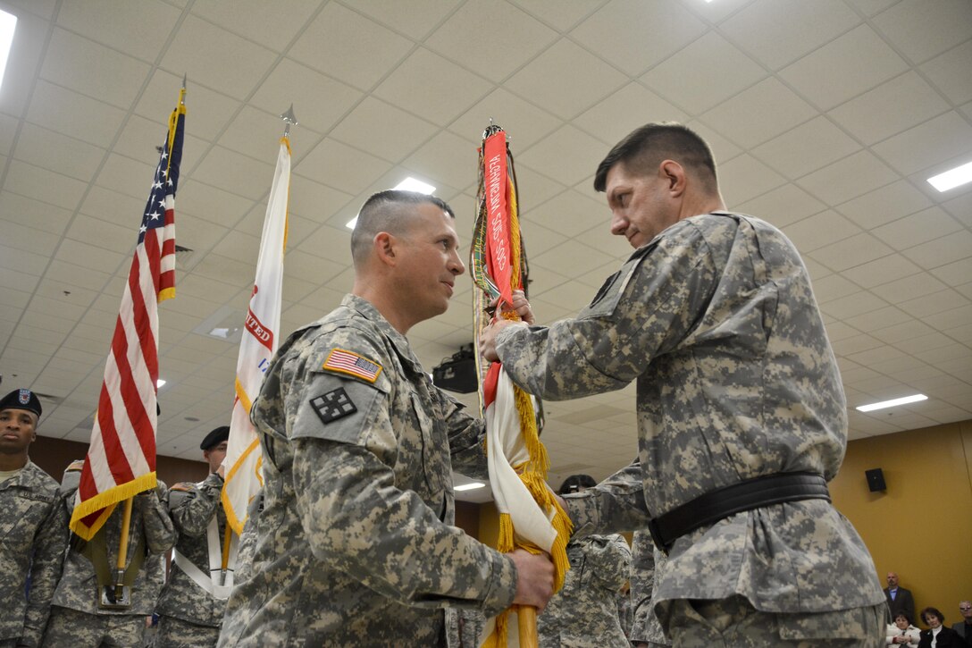 U.S. Army Reserve Maj. Gen. Tracy A. Thompson (right), commanding general, 412th Theater Engineer Command, passes the 411th Engineer Brigade colors to Col. Matthew Warne, incoming commander, 411th Engineer Brigade, signifying his acceptance of command during the change of command ceremony March 5 in New Windsor, N.Y. (U.S. Army photo by Nathan Fanton)