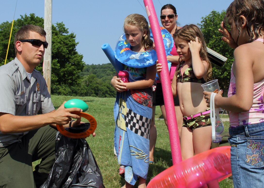 Park Ranger Dean Austin, natural resource specialist, hands out water safety promotional items with visitors of Cheatham Lake at Right Bank recreation area July 11, 2015. (USACE photo by Kyle Beverly)