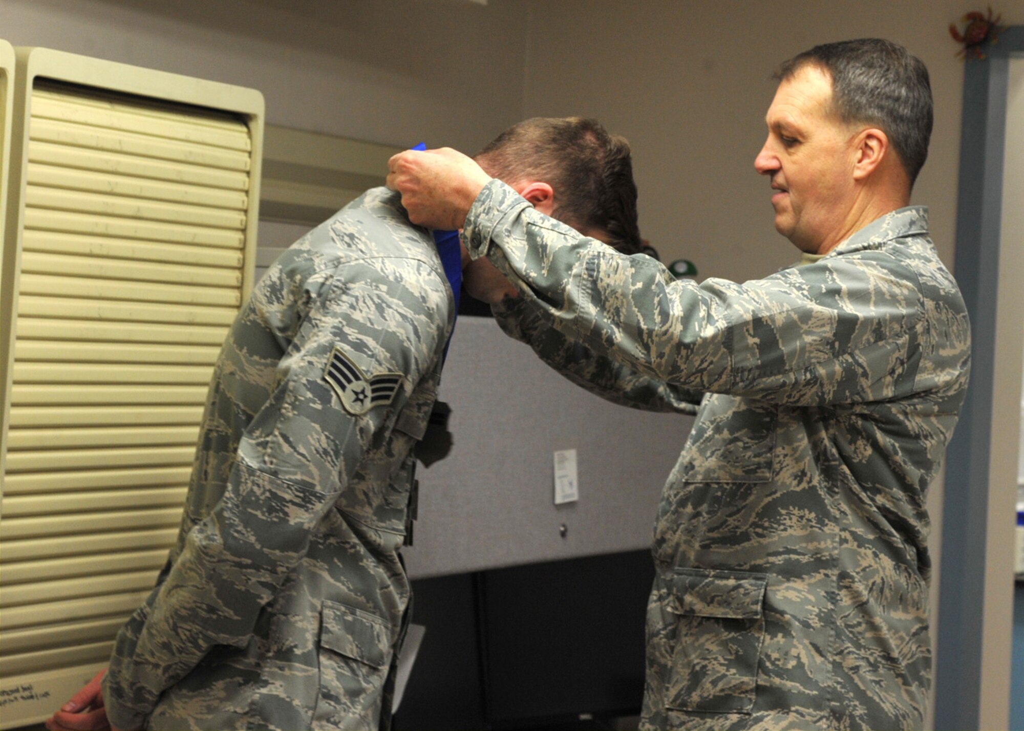 Brig. Gen. Kory Cornum, right, Air Mobility Command surgeon general, presents Senior Airman Joshua Fleek, 319th Medical Support Squadron radiology technician, with the Air Mobility Command Surgeon General “Real Pro” Award March 4, 2016, on Grand Forks Air Force Base, North Dakota. Fleek was presented with the award for exemplifying excellence. (U.S. Air Force photo by Airman 1st Class Ryan Sparks/Released)