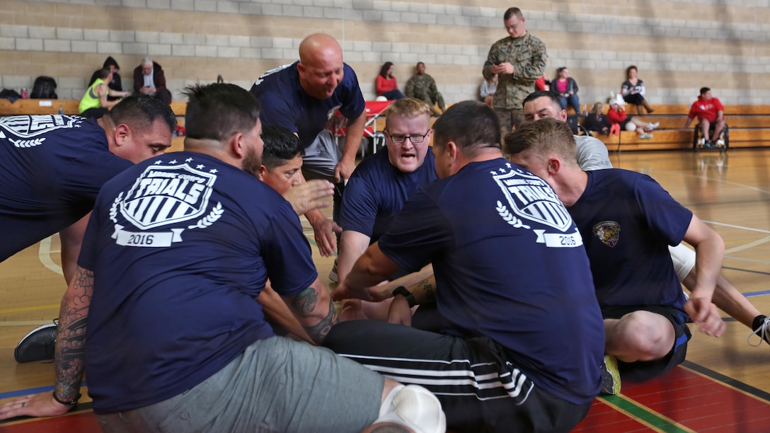 Wounded Warrior Battalion-West Marines huddle during seated volleyball practice during the Marine Corps Trials at Marine Corps Base Camp Pendleton, Calif., March 6, 2016. The Trials, an eight-event adaptive sports competition, is hosted by the Wounded Warrior Regiment, the Marine Corps command that facilitates the integration of non-medical and medical care to wounded, ill, and injured Marines and their families. The Trials began March 2, 2016, and end March 9, 2016.