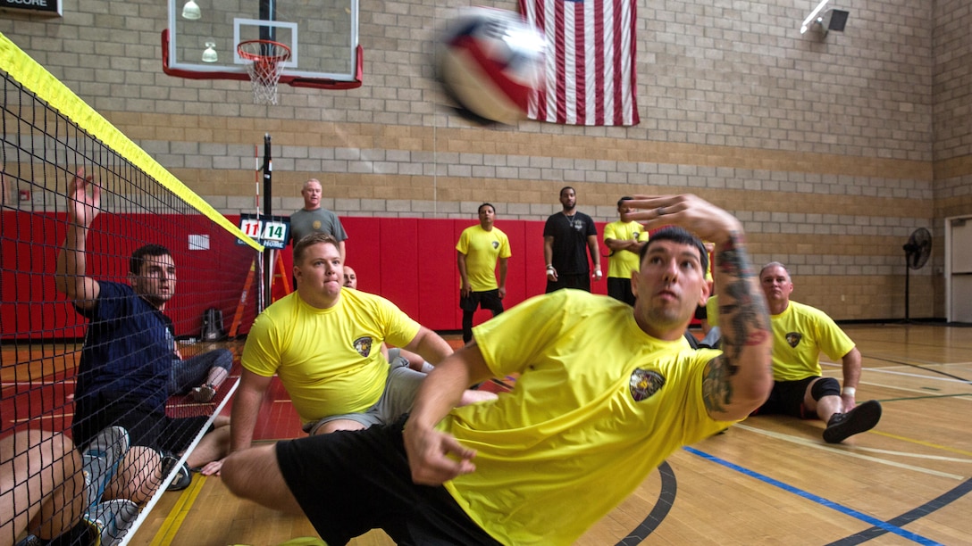 U.S. Marine Corps Sgt. Zach Guess, a Marion, Ky., native with Wounded Warrior Battalion– East, lobs a volleyball toward the opposing team at a volleyball competition during the 2016 Marine Corps Trials at Marine Corps Base Camp Pendleton, March 6, 2016. Over the course of the 6th annual Trials, wounded, ill, and injured Marines and veterans will compete in a variety of different events, such as archery, shooting, track and field, swimming, wheelchair basketball and seated volleyball.