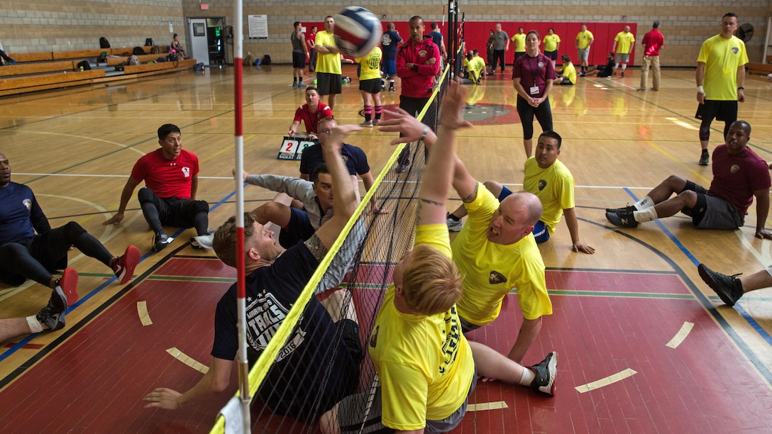 U.S. Marines and veterans with the Wounded Warrior Regiment face off in a game of seated volleyball during the 2016 Marine Corps Trials at Marine Corps Base Camp Pendleton, Calif., March 6, 2016. The Trials, an eight-event adaptive sports competition, is hosted by the Wounded Warrior Regiment, the Marine Corps command that facilitates the integration of non-medical and medical care to wounded, ill, and injured Marines and their families. The Trials began March 2, 2016, and end March 9, 2016.