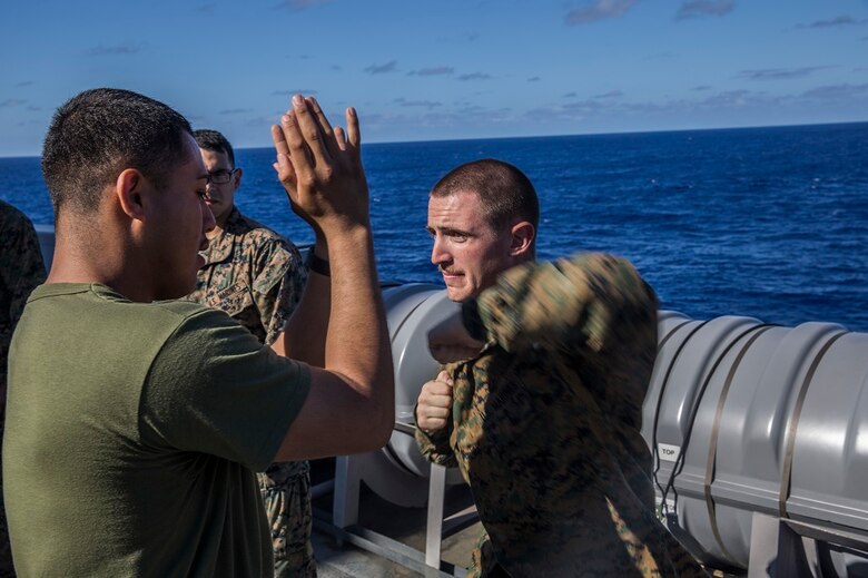 U.S. Marine Cpl. Logan French (right), a combat engineer with the 13th Marine Expeditionary Unit, practices horizontal elbow strikes during a Marine Corps Martial Arts Program class aboard the USS New Orleans, at sea, Feb. 29, 2016. The techniques learned in MCMAP build and enhance as Marines progress through the levels. More than 4,500 Sailors and Marines from the Boxer Amphibious Ready Group, 13th Marine Expeditionary Unit team are currently transiting the Pacific Ocean toward the U.S. 7th Fleet area of operations during a scheduled deployment. (U.S. Marine Corps photo by Lance Cpl. Alvin Pujols/RELEASED)