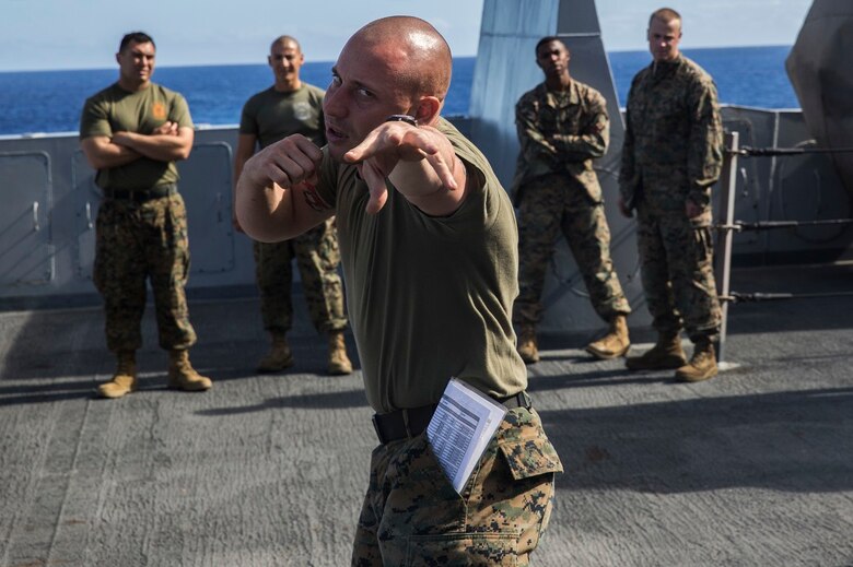 U.S. Marine Cpl. Francis Mueller, a Marine Corps Martial Arts Program instructor and heavy equipment mechanic with the 13th Marine Expeditionary Unit, demonstrates a proper eye gouge during a MCMAP class aboard the USS New Orleans, at sea, Feb. 29, 2016. MCMAP teaches the fundamentals of hand-to-hand combat and ground fighting, along with leadership traits and warrior ethos. More than 4,500 Sailors and Marines from the Boxer Amphibious Ready Group, 13th Marine Expeditionary Unit team are currently transiting the Pacific Ocean toward the U.S. 7th Fleet area of operations during a scheduled deployment. (U.S. Marine Corps photo by Lance Cpl. Alvin Pujols/RELEASED)
